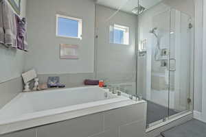 Bathroom with a garden tub and a stall shower