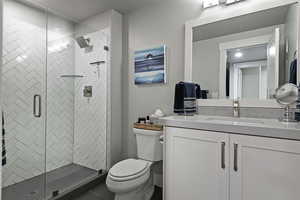 Bathroom featuring vanity and a stall shower