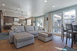 Living room with dark wood-style flooring, recessed lighting, and a textured ceiling