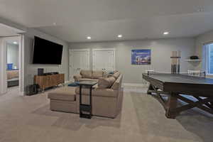 Living area featuring recessed lighting and light carpet