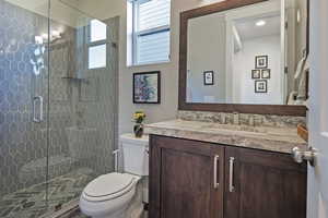 Full bathroom featuring vanity, a stall shower, and a chandelier