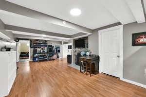 Interior space with light wood-style floors and a fireplace with flush hearth