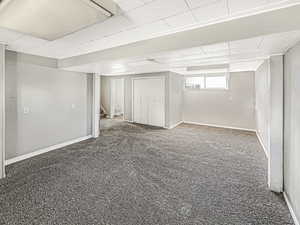 Below grade area with stairway and carpet flooring