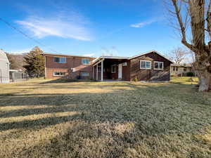 Rear view of house with a patio area and a carport
