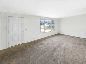Spare room featuring carpet flooring