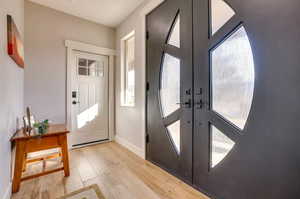 Entrance foyer featuring french doors and light wood finished floors