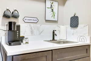 Bar area featuring light countertops and a sink