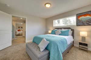 Bedroom featuring light carpet