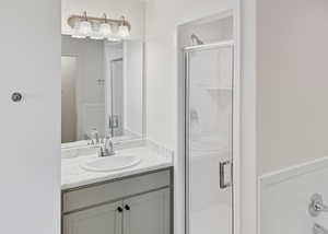 Bathroom with vanity and a shower stall