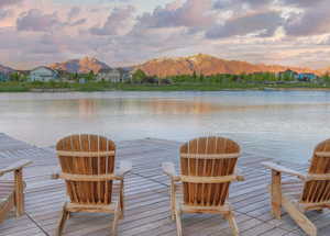 Dock featuring a water and mountain view and a residential view