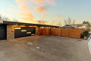 Garage at dusk featuring driveway