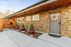 Doorway to property featuring a gate and a patio