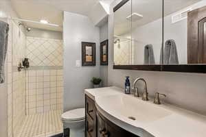 Bathroom featuring vanity and a stall shower