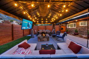 Fenced backyard with an outdoor living space with a fire pit and a patio area