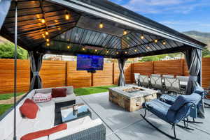 Fenced backyard with outdoor lounge area and a patio