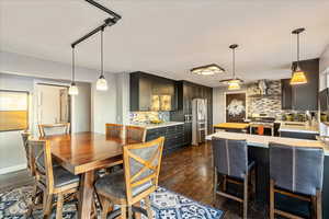 Dining space with dark wood-type flooring