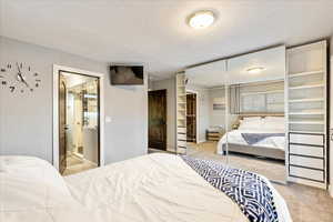 Bedroom with a closet and light colored carpet