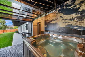 View of patio with a hot tub