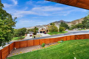 Fenced backyard featuring a mountain view and a gate