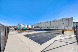View of tennis court featuring a residential view, a gazebo, and community basketball court
