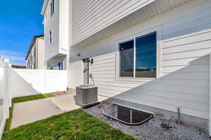 View of home's exterior with a patio area and a cooling unit