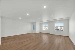 Empty room featuring light wood-style flooring and recessed lighting