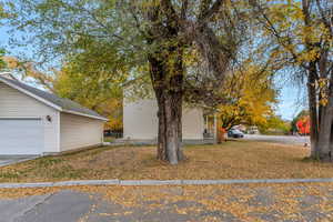 View of side of home featuring an outdoor structure