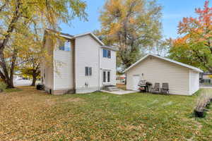 Rear view of property featuring a yard, a patio area, french doors, and entry steps
