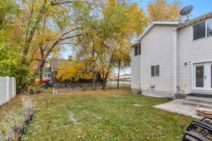 Fenced backyard with entry steps and a patio area