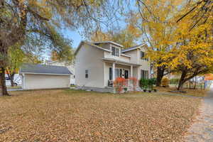View of front of property featuring covered porch and a front yard