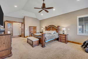Bedroom with ceiling fan, vaulted ceiling, recessed lighting, and light colored carpet