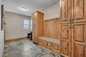 Mudroom with a textured ceiling