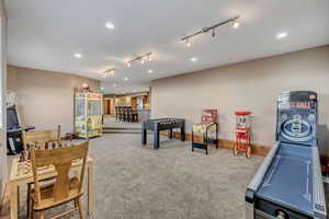 Rec room with recessed lighting, carpet flooring, and rail lighting