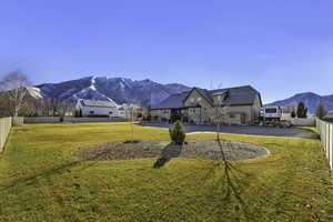 Fenced backyard featuring a mountain view