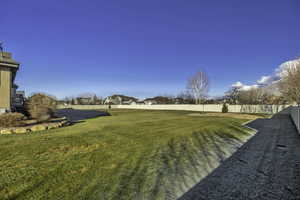 Fenced backyard with a residential view