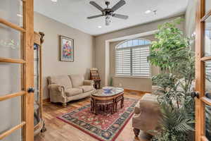 Sitting room featuring hardwood / wood-style floors, a ceiling fan, and recessed lighting