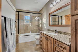Full bathroom with vanity and combined bath / shower with glass door