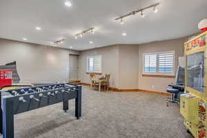 Playroom with track lighting, light colored carpet, and recessed lighting