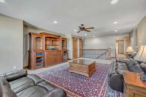 Living room with recessed lighting, a textured ceiling, and ceiling fan