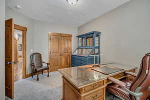 Office area featuring a textured ceiling