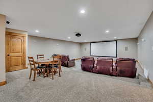 Cinema featuring recessed lighting and light colored carpet
