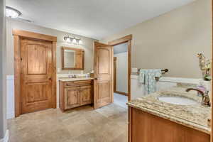 Full bathroom featuring two vanities