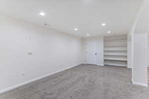 Unfurnished room featuring recessed lighting and light carpet