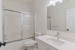 Full bath with vanity and shower / bath combination with glass door