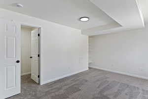 Carpeted spare room with baseboards