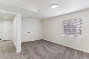 Unfurnished room with carpet and baseboards