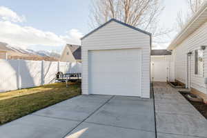 Detached garage with concrete driveway