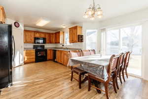 Dining room with a chandelier and light wood finished floors