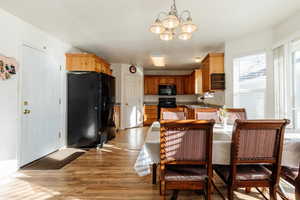 Dining space featuring light wood-style flooring and a chandelier