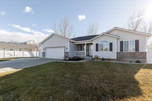 Ranch-style house featuring covered porch, concrete driveway, and an attached garage